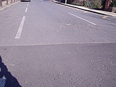 Damage to road at speed hump - Coppermine - 5106.JPG