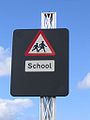 Modern school sign with warning for a variable speed limit